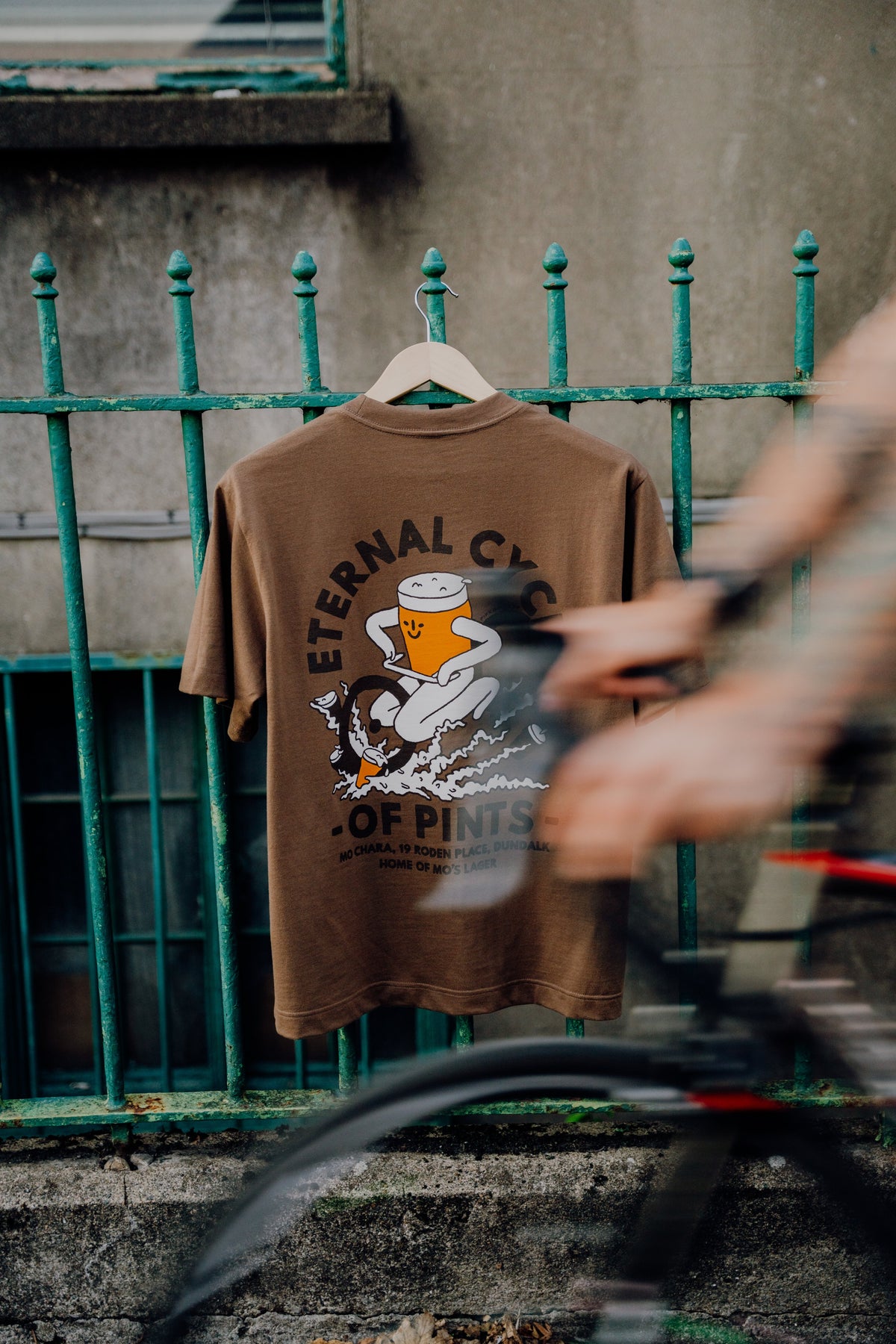 eternal cycle of pints tee hanging on railings